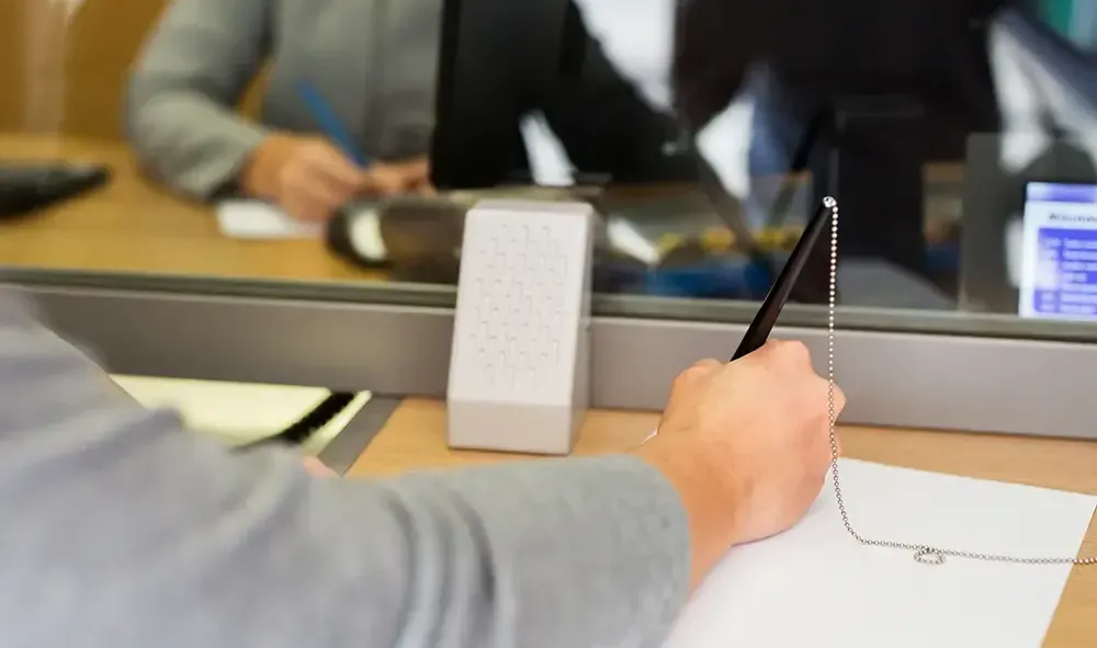 person at bank window