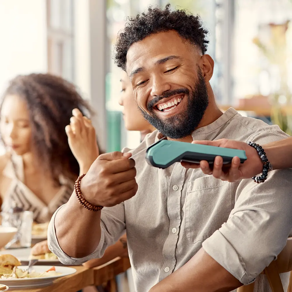 man paying with credit card