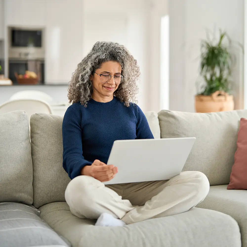 woman on sofa with laptop